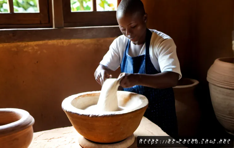 코트디부아르 푸푸 만드는 법 - Photorealistic West African home kitchen scene showing an Ivorian cook pounding smooth white fufu do...